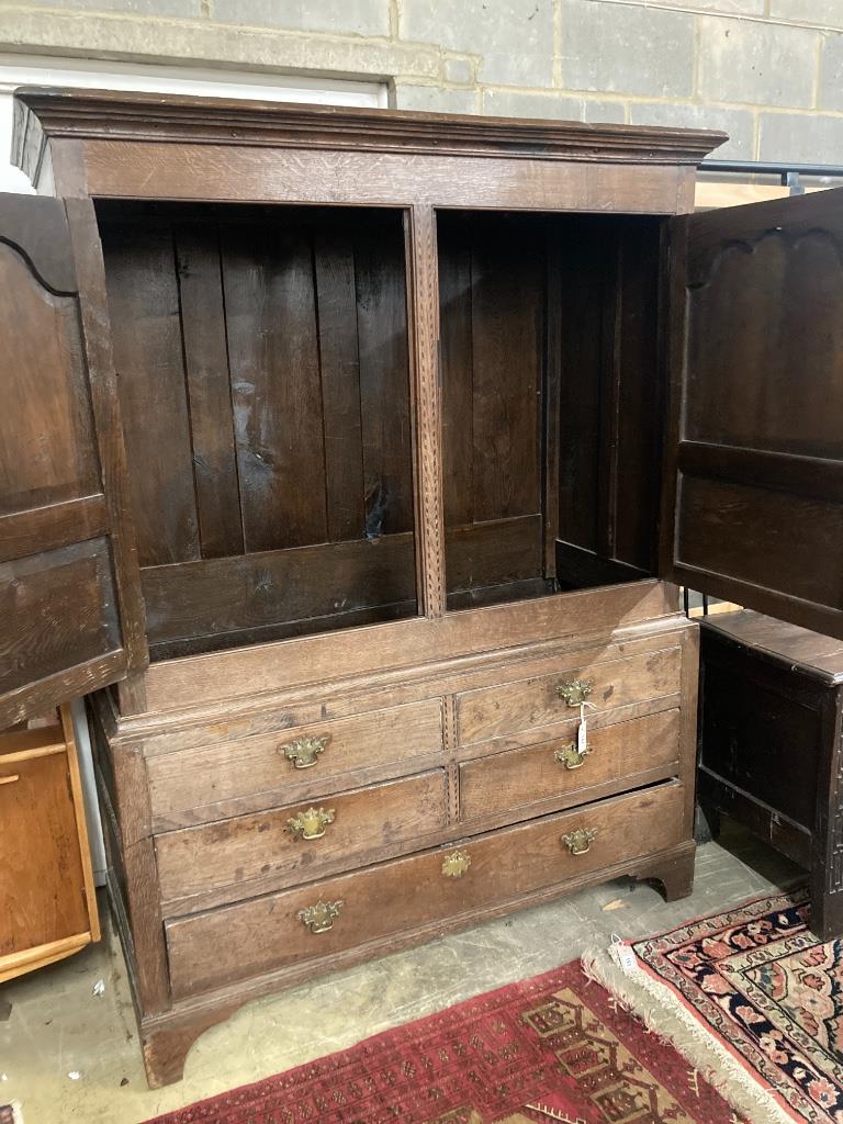 A George III inlaid oak press cupboard, width 140cm, depth 60cm, height 184cm